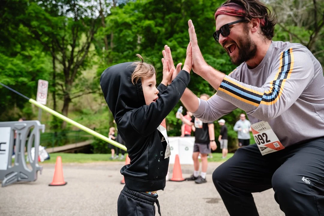 A runner and child sharing a high five at the 2026 Sewickley Classic