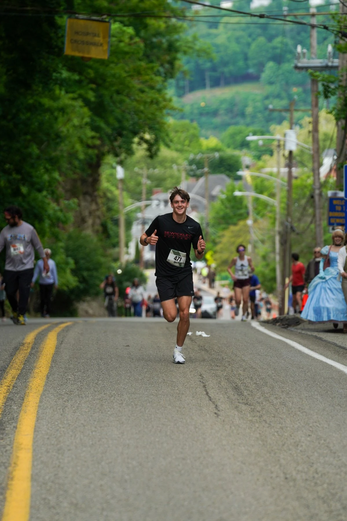 A young runner climbing the Sewickley Classic course